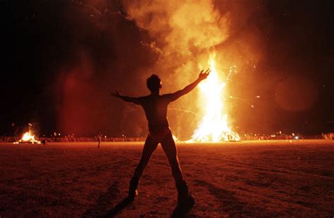 man runs into fire at burning man